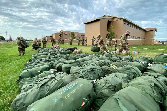 U.S. Soldiers with the 28th Expeditionary Combat Aviation Brigade unload bags from a truck at their mobilization station at Fort Hood, Texas. They are at their mobilization to train, after which the 28th ECAB will deploy to the Middle East where they will assist U.S. Central Command’s mission of increasing regional security and stability in support of U.S. interests.