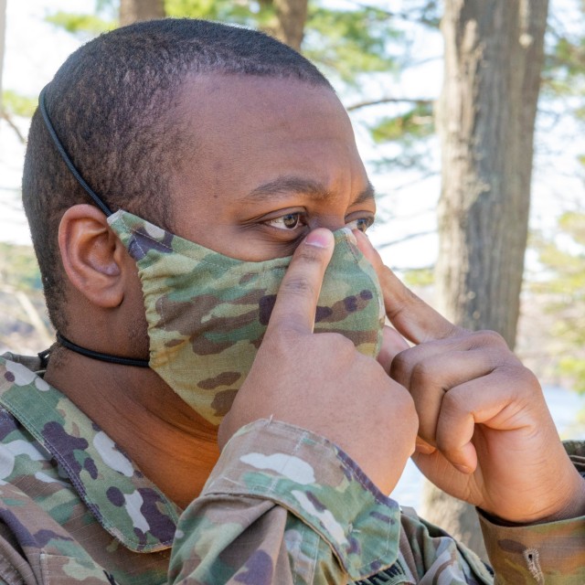 Staff Sgt. Christian King-Lincoln tries on face covering prototype