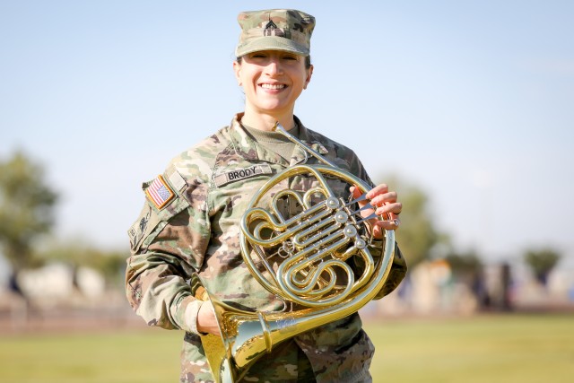 FORT BLISS, Texas - Cpl. Caitlin Brody, a musician assigned to the 1st Armored Division Band and native of Albuquerque, New Mexico, poses with her french horn at Iron Soldier Field, Fort Bliss, Texas, July 16. Brody’s determination, technical excellence and Soldier skills aided her in being named the Army Band Active Component Soldier of the Year this year, being selected from 275 other active duty Army Band Soldiers by a panel of senior leaders. (U.S. Army photo by Pfc. Matthew Marcellus)