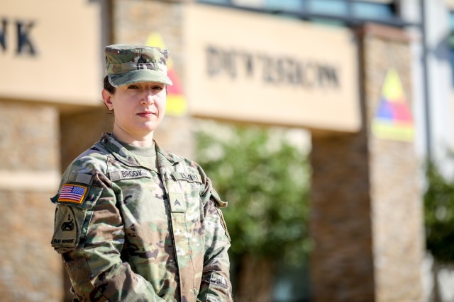 FORT BLISS, Texas - Cpl. Caitlin Brody, a musician and french horn player assigned to the 1st Armored Division Band and native of Albuquerque, New Mexico, poses in front of the 1AD headquarters at Fort Bliss, Texas, July 16. Brody won this year’s Army Band Active Component Soldier of the Year honor from among 275 other active Army Band Soldiers, demonstrating the total Soldier concept and technical skill that is integral to the Army Band’s success. (U.S. Army photo by Pfc. Matthew Marcellus)