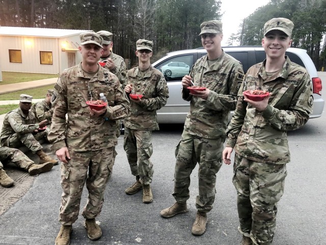 Pictured from left to right are Sgt 1st Class Joshua Lambert, Cpl. Gage Ybarra, Spc. Collin Ronje, 1st Lt. Evan Wachowski, 511th Military Police Company, 91st Military Police Battalion, 10th Mountain Division, eating a batch of red beans and rice made for them during a Joint Readiness Training Center rotation in Feb. 2019.