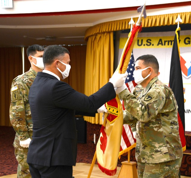 Col. Jason Edwards, former USAG Rheinland-Pfalz commander, right, hands the garrison colors to Tommy Mize, Installation Management Command-Europe director, during the change of command ceremony July 22 in Kaiserslautern.
Photo by Elisabeth Paque