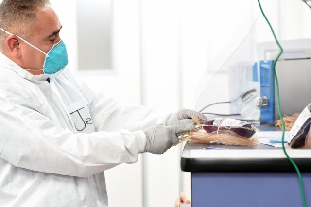 A laboratory technician with the Armed Services Blood Program prepares blood donations to be sent for coronavirus antibody testing, July 15, 2020, at Fort Bliss, Texas.