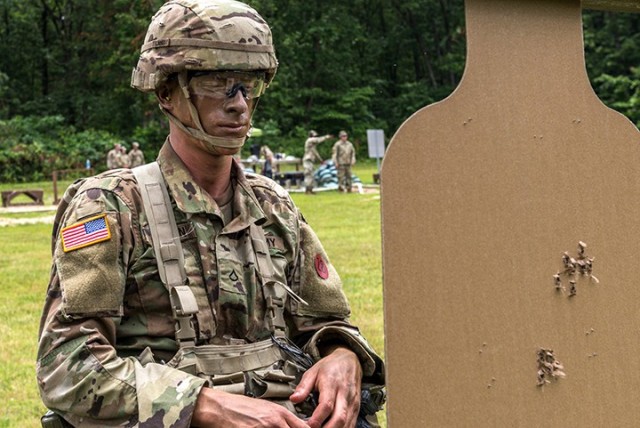 Spc. Scott Sartin, 526th Military Police Company, 40th MP Battalion (Detention), looks at his target during the range portion of the Best Warrior Competition June 29 at Fort Leonard Wood, Mo. Fort Leavenworth Best Warrior participants competed in...