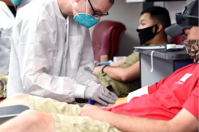 Sgt. Michael Furman, an Armed Services Blood Program technician, collects blood from Staff Sgt. Chris Frost with the 2nd Battalion, 501st Aviation Regiment at Fort Bliss, Texas. Frost said he saw the blood donation bus parked at Freedom Crossing July 15 and he stopped to donate blood because he has blood type O negative, which he said is always in high demand. Frost said, “A few minutes of my time could mean the lifetime of somebody else because this blood is potentially on its way over to Afghanistan to save somebody’s life. So, a little bit of my time to save some of my brothers, I’m okay with it.”