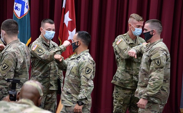 Combined Arms Center and Fort Leavenworth Soldier of the Year Spc. Thomas Snell, 165th Military Police Company, 705th MP Battalion (Detention), and runner-up Spc. Scott Sartin, 526th Military Police Company, 40th MP Battalion (Detention), receive...