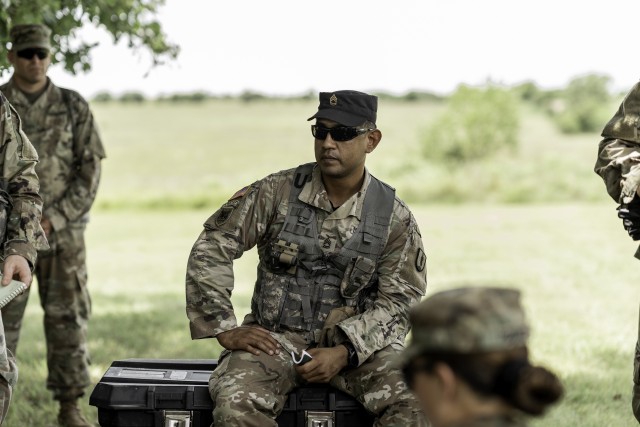Sgt. 1st Class Dominic Cantu, training noncommissioned officer of the Officer Candidate School, critiques a recently given operations order brief in order to refine the candidates briefing skills before they depart for Phase III of their OCS training. Officer Candidate School Class 64 of 1st Battalion, 235th Regiment conducted training at the Kansas National Guard Range Training Complex in Salina, Kansas, June 27-28. (Photo by Capt. Lauren Orr, 105th Mobile Public Affairs Detachment.)