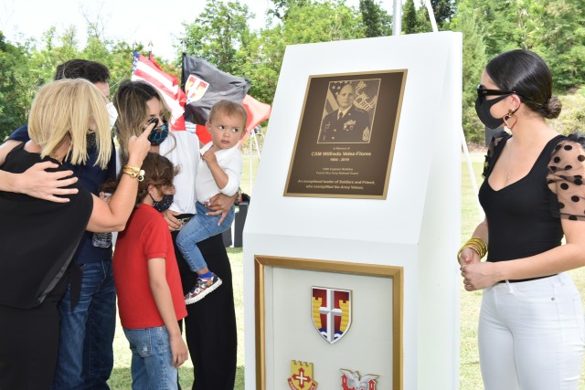 The family of late Command Sgt. Maj. Wilfredo Vélez Flores of the Puerto Rico Army National Guard admire the plaque in his honor at the Memorialization – Dedication Ceremony of the recently renovated running track in Fort Buchanan held July 14,...