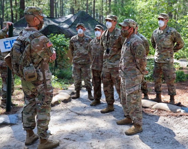 Sgt. Maj. of the Army Michael A. Grinston visits with 82nd Airborne Division Soldiers as they go through Expert Infantry and Soldier Badge training on Fort Bragg, N.C., June 22, 2020. Grinston announced changes to promotion boards and Best Warrior competitions to help combat sexual harassment and assault during a town hall July 22. 