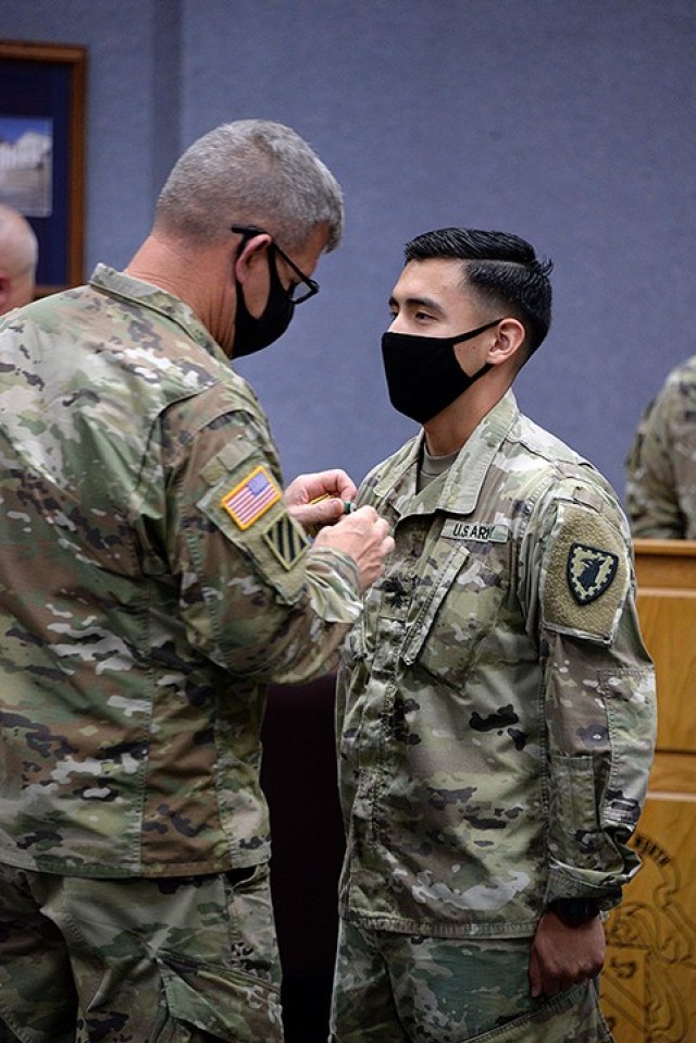 Combined Arms Center and Fort Leavenworth Commanding General Lt. Gen. James Rainey pins NCO of the Year Sgt. Bryan Jacobo, 15th Military Police Brigade, with the Army Commendation Medal during a ceremony recognizing Jacobo as CAC and Fort...