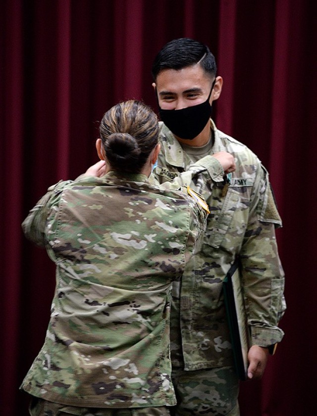 Combined Arms Center and Fort Leavenworth NCO of the Year Sgt. Bryan Jacobo, 15th Military Police Brigade, receives a congratulatory elbow bump from 15th MP Brigade Commander Col. Caroline Smith after a ceremony recognizing Jacobo as CAC NCO of...