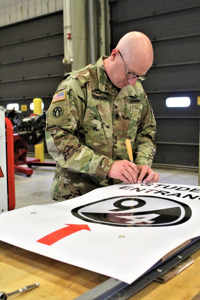 Sgt. 1st Class Mark E. Olson-Jones, a Regional Training Site-Maintenance instructor, prepares signs for use for training July 16, 2020, in building 1370 at Fort McCoy, Wis. The Regional Training Site-Maintenance staff resumed their institutional training courses in July 2020. (U.S. Army Photo by Scott T. Sturkol, Public Affairs Office, Fort McCoy, Wis.)