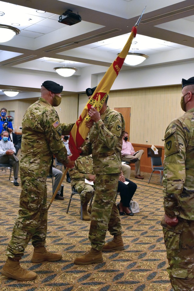 On July 16, 2020, U.S. Army Garrison Fort Riley hosted a change of command ceremony between Col. Stephen Shrader and Col. William B. McKannay.  Col. Stephen Shrader, left, passes the garrison colors to Col. William McKannay as the sign of the formal change of the command.