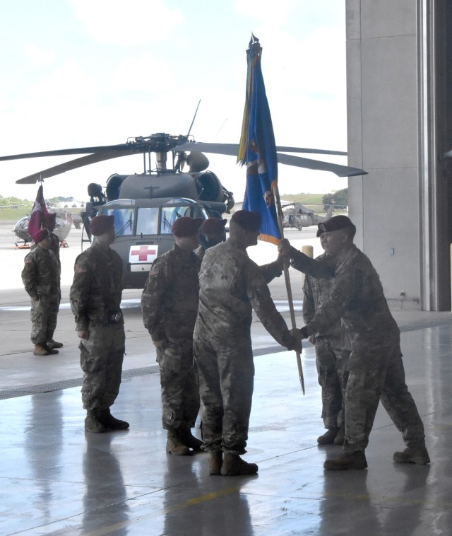 Brig. Gen. Patrick D. Frank, commander, Joint Readiness Training Center and Fort Polk (right) passes the 1st Battalion, 5th Aviation Regiment colors to incoming 1st Bn, 5th Avn Reg commander Lt. Col. JD Swinney during a change of command ceremony...