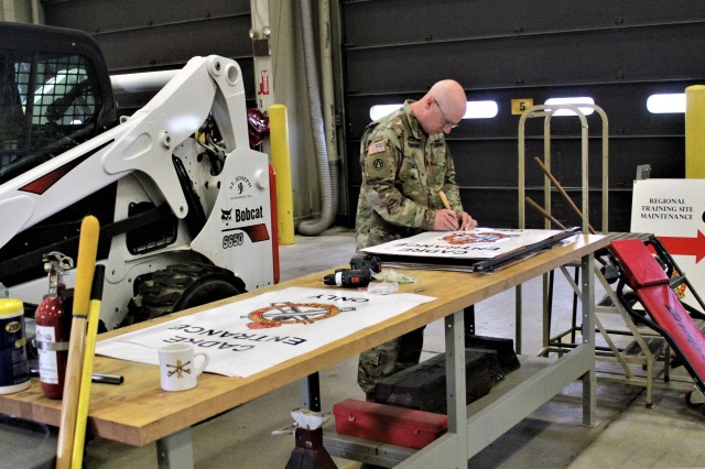 Sgt. 1st Class Mark E. Olson-Jones, a Regional Training Site-Maintenance instructor, prepares signs for use for training July 16, 2020, in building 1370 at Fort McCoy, Wis. The Regional Training Site-Maintenance staff resumed their institutional training courses in July 2020. (U.S. Army Photo by Scott T. Sturkol, Public Affairs Office, Fort McCoy, Wis.)