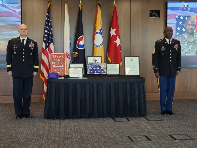Gen. Edward Daly, left, commanding general of Army Materiel Command, and Command Sgt. Maj. Gene Canada, right, USASAC's former command sergeant major, listen to a Legion of Merit awards citation at a retirement ceremony honoring Canada’s 33...