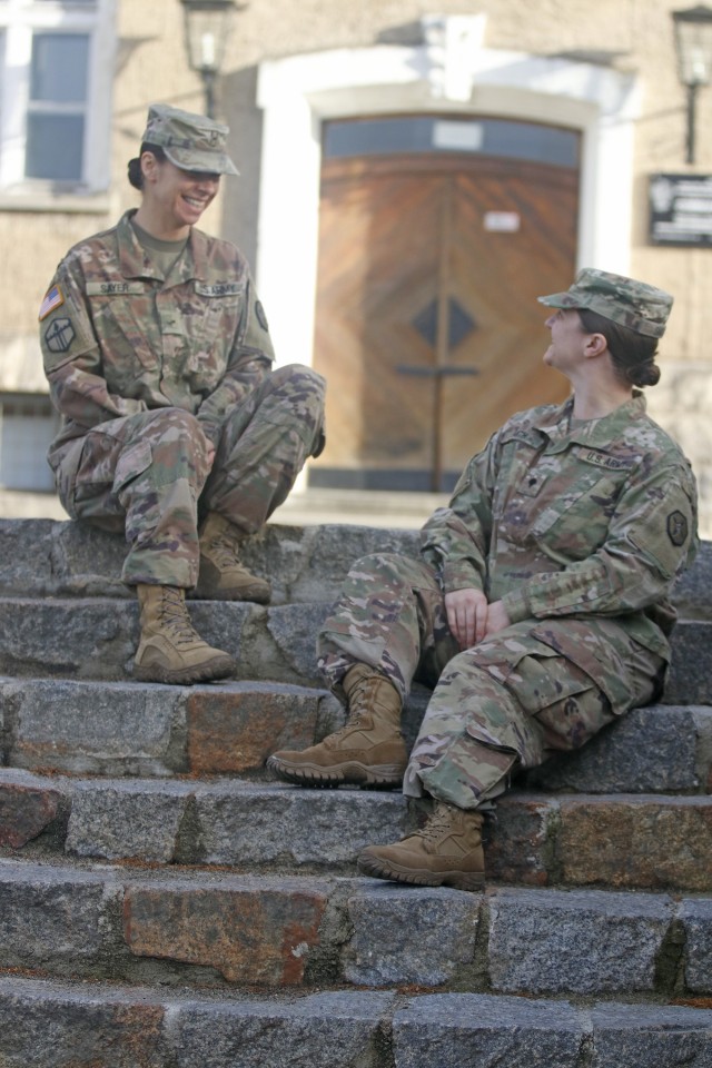 Warrant Officer Carrie Sayer, an allied trade specialist from Boise, Idaho, left, and Spc. (now Sgt.) Lauren Smith, an intelligence noncommissioned officer from Cassville, Pennsylvania, both with the 652nd Regional Support Group out of Helena, Montana, talk on the steps of the Boleslawiec base camp December 17, 2019. Sayer and Smith served as the mayor and deputy mayor, respectively, of the Boleslawiec base camp in Boleslawiec, Poland. The base camp was one of 11 base camps throughout the country of Poland where the 652nd RSG led base operations during their 10-month deployment to Poland. (U.S. Army Reserve photo by Master Sgt. Ryan C. Matson, 652nd Regional Support Group)