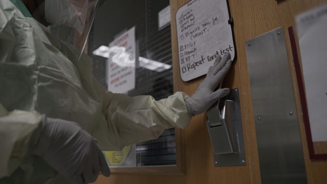 A provider enters a patient room in a COVID-19 intensive care unit at Brooke Army Medical Center, July 17, 2020. (U.S. Army photo by James Camillocci)