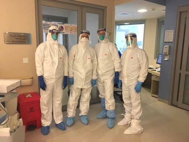 U.S. Air Force Dr. (Col) Terry Lonergan, (2nd from right) and SSMC colleagues wearing personnel protective equipment to check on 
...