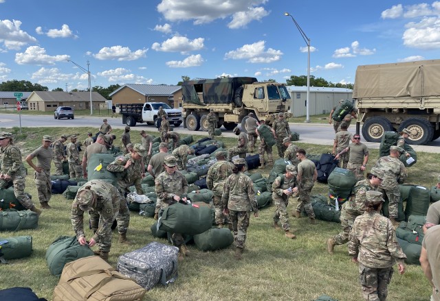 Soldiers from the U.S. Army Reserve’s 652nd Regional Support Group out of Helena, Montana, and the New Mexico National Guard’s 1209th Medical Company (Area Support) from Rio Rancho, New Mexico, gather their duffel bags after arriving for quarantine July 20 at North Fort Hood, Texas. The two units are wrapping up a nearly year-long deployment to Poland in support of Atlantic Resolve together. (U.S. Army Reserve photo by Master Sgt. Ryan C. Matson, 652nd Regional Support Group)