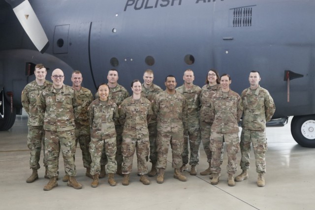 Soldiers from the 652nd Regional Support Group’s Zagan cluster mayor cell teams pose together for a photo July 8 following the ceremony transferring authority from the 652nd RSG to the 297th RSG in the hangar on Powidz Air Base, Powidz, Poland. The 652nd RSG is wrapping up a nearly year-long deployment to Poland in which they led base operations on 11 base camps throughout Poland. (U.S. Army Reserve photo by Master Sgt. Ryan C. Matson, 652nd Regional Support Group)