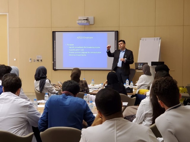 Air Force Lt. Col. Brian Gavitt, one of the joint U.S. service members of the Trauma, Burn, and Rehabilitative Medicine team (TBRM), briefs fellow medical officers and staff at the Sheikh Shakhbout Medical City in Abu Dhabi. The TBRM mission is to...