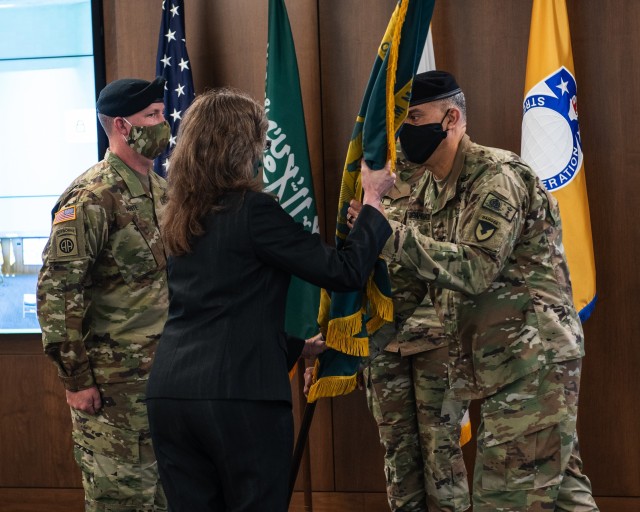 Col. John DiGiambattista, right, passes the unit flag to Dr. Myra Gray, the Executive Director of U.S. Army Security Assistance Command during a Change of Charter ceremony for the Office of the Program Manager-Saudi Arabian National Guard Modernization Program (OPM-SANG), on July 1, at Redstone Arsenal, AL. Col. DiGiambattista, the outgoing program manager, relinquished his duties to Col. John White. (US Army photo by Richard Bumgardner)
