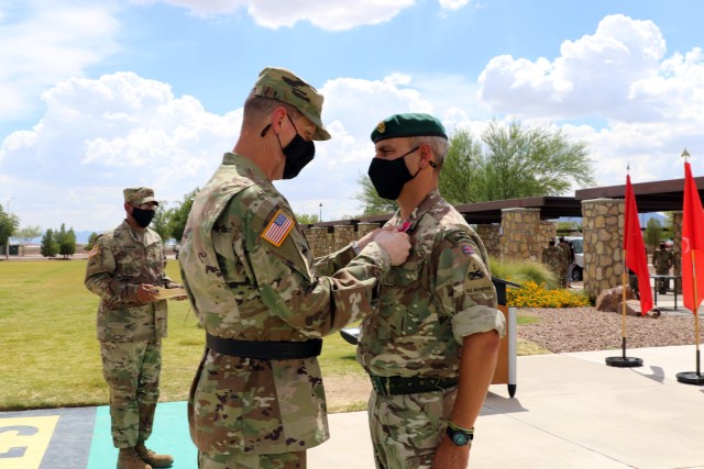 Fort Bliss, Texas - Maj. Gen. Patrick Matlock, the commanding general of 1st Armored Division and Fort Bliss, pins the Legion of Merit to British Army Brigadier Leigh Tingey’s lapel, a native of Cambridge, England, the outgoing deputy commanding general-maneuver of 1AD, during a farewell retreat ceremony held in Tingey’s honor at Fort Bliss, Texas, July 23. (U.S. Army photo by Jean S. Han)