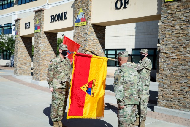 Maj. Gen. Patrick Matlock, the commanding general of 1st Armored Division and Fort Bliss, left, and Sgt. Maj. Joseph Denny, the 1AD operations sergeant major, stand at attention after uncasing the 1AD colors at Fort Bliss, Texas, July 2. The uncasing of the colors is a tradition which signifies the return of a unit from a deployment, formally marking 1AD's Headquarters and Headquarters Battalion's return from a deployment to Afghanistan which began last summer. (U.S. Army photo by Pfc. Matthew Marcellus)