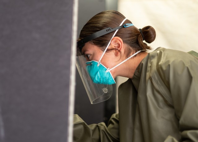 Spc. Casandra Corpus, a combat medic assigned to Headquarters and Headquarters Company, 2nd Battalion, 23rd Infantry Regiment, 1st Stryker Brigade Combat Team, 4th Infantry Division, conducts a COVID-19 test on a Soldier at the Centralized Screening and Testing Center at Fort Carson, Colorado, July 25, 2020. The 1st SBCT tested more than 180 Soldiers for COVID-19 in preparation for the unit's upcoming rotation to the National Training Center at Fort Irwin, California. (U.S. Army photo by Capt. Daniel Parker)