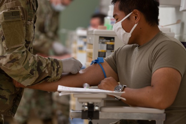 Pfc. Kenneth Valdehueza, an indirect fire infantryman assigned to Bravo Company, 4th Battalion, 9th Infantry Regiment, 1st Stryker Brigade Combat Team, 4th Infantry Division has his arm swabbed with alcohol prior to a blood draw at the Soldier Readiness Processing (SRP) Center at Fort Carson, Colorado, July 17, 2020. The Fort Carson SRP site expanded its hours to accommodate the 1st SBCT's Emergency Deployment Readiness Exercise while also ensuring proper social distancing and wearing of face coverings. (U.S. Army photo by Capt. Daniel Parker)