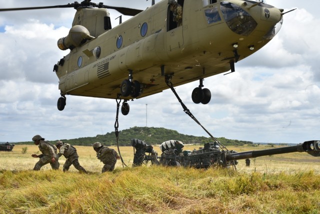 Troopers from B Battery, Field Artillery Squadron, 3rd Cavalry Regiment, retreat after preparing the M777A2 Howitzer for Sling Load by a CH47 during Steel’s Gun Raid training event July 27 at Fort Hood. (U.S. Army photo by Maj. Marion Jo Nederhoed)