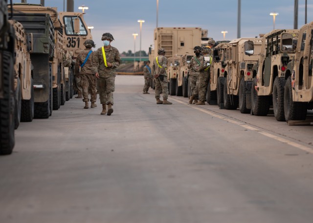 Soldiers assigned to 4th Battalion, 9th Infantry Regiment, 1st Stryker Brigade Combat Team, 4th Infantry Division, prepare to move their vehicles onto railcars during rail yard operations at Fort Carson, Colorado, July 23, 2020. The 1st SBCT executed a no-notice Emergency Deployment Readiness Exercise while preparing for its upcoming rotation to the National Training Center. (U.S. Army photo by Capt. Daniel Parker)