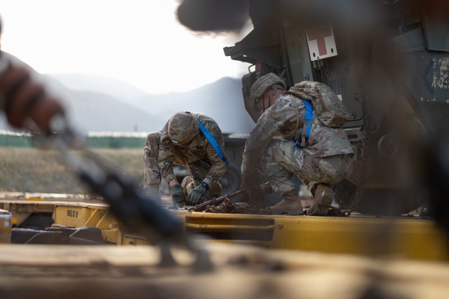 Soldiers assigned to 3rd Armored Brigade Combat Team, 4th Infantry Division, secure chains to a 1st Stryker Brigade Combat Team M1133 medical evacuation vehicle at Fort Carson, Colorado, July 23, 2020. The 1st SBCT executed a no-notice Emergency Deployment Readiness Exercise while preparing for its upcoming rotation to the National Training Center. (U.S. Army photo by Capt. Daniel Parker)