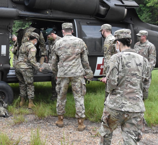 Medics from units across the Joint Readiness Training Center and Fort Polk practice loading a litter patient into a medevac helicopter belonging the the 1st Battalion, 5th Aviation Regiments's Cajun Dustoff..