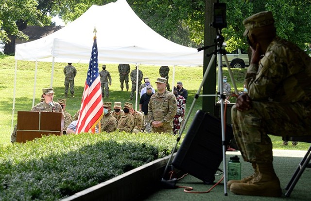 Outgoing 15th Military Police Brigade Commander Col. Caroline Smith delivers remarks as ceremony narrator 1st. Lt. Justin Overman and other ceremony attendees listen and a virtual audience watches via a Facebook feed monitored by 40th Military...