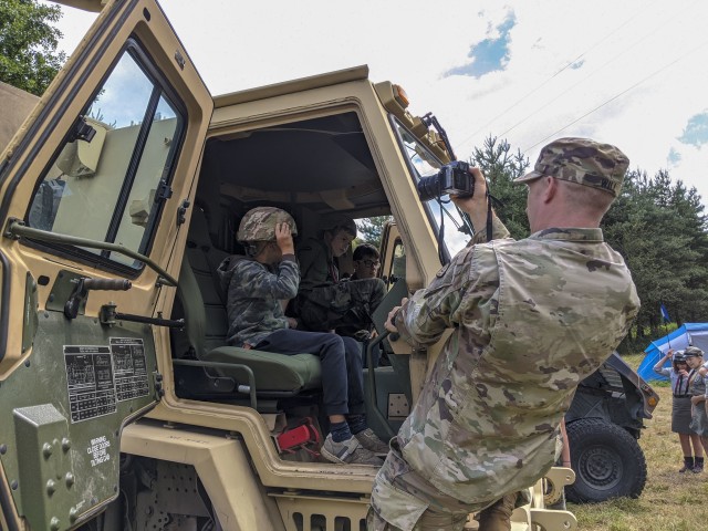 U.S. Army Sgt. 1st Class Dayton Will, Forward Operating Site Świętoszów deputy mayor, with the Alaska National Guard’s 297th Regional Support Group, takes a photo of Polish scouts inside a medium tactical vehicle at Camp Watra near Osieczow,...
