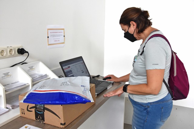 WIESBADEN, Germany - A customer uses a laptop provided by the Wiesbaden Postal Service Center to fill out an online customs form July 27. Beginning Aug. 13, the Wiesbaden Postal Service Center will no longer accept hand-written customs forms when mailing packages.