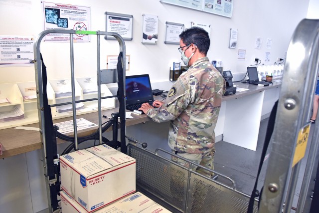 WIESBADEN, Germany - A customer uses a laptop provided by the Wiesbaden Postal Service Center to fill out an online customs form July 27. Beginning Aug. 13, the Wiesbaden Postal Service Center will no longer accept hand-written customs forms when mailing packages.