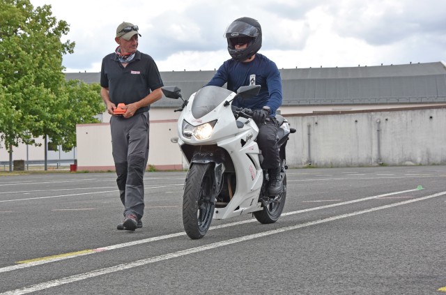 WACKERNHEIM, Germany - Stefan Bockisch, instructor for the Army’s motorcycle safety courses, gives feedback to 2nd Lt. Mike DeRosa, with the 525th Military Working Dog Detachment, as he completes maneuvers during the Basic Rider Course July 28 at McCully Barracks. Soldiers must pass the BRC to be able to operate a motorcycle while stationed in Europe.