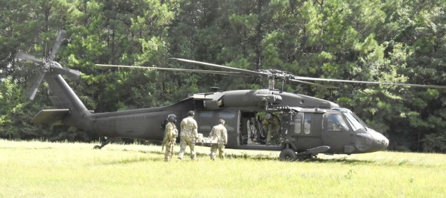 A team of medics carry a litter patient to an awaiting medevac helicopter during training July 24 adjacent to Fort Polk’s Bayne-Jones Community Hospital, conducted by the hospital education and staff development office and 1st Battalion, 5th Aviation Regiment’s Cajun Dustoff.