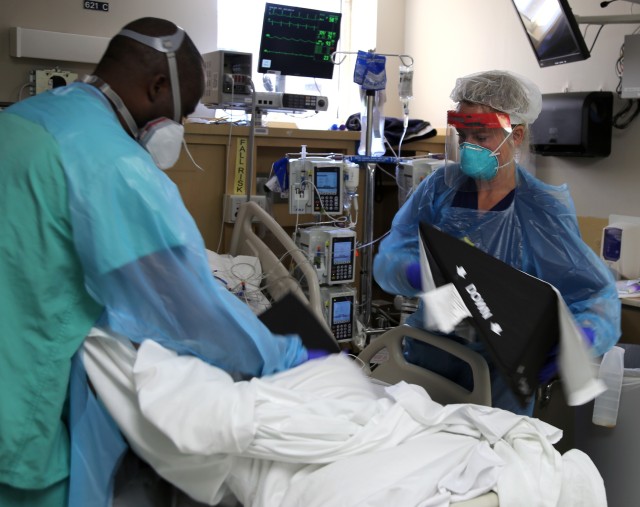 Capt. Stacey Johnson, critical care nurse from Urban Augmentation Medical Task Force-627, provides positioning aids to a COVID-19 patient, July 10, 2020 at Baptist Hospital, in San Antonio, Texas. Driven by a three-phase emergency response plan,...