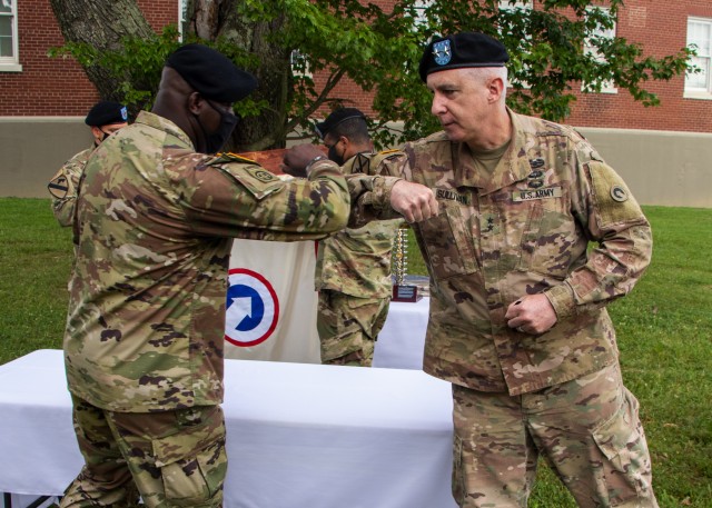 Maj. Gen. John P. Sullivan, commanding general of 1st Theater Sustainment Command, shares an elbow tap with Command Sgt. Maj. Bernard P. Smalls Sr., outgoing senior enlisted advisor, 1st TSC, during an awards ceremony at Fort Knox, Kentucky, July...