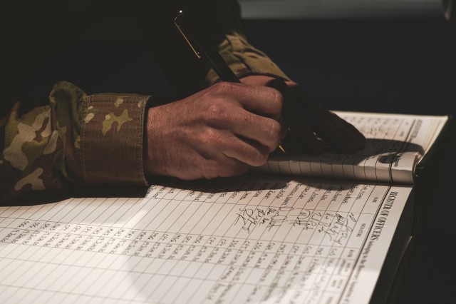 U.S. Soldier, assigned to the Regimental Support Squadron, 2d Cavalry Regiment, signs the Book of the Dragoons during the Dragooning Ceremony at the Reed Museum in Vilseck, Germany, June 19, 2020. The book dates back to 1836 with its first signature by Maj. Gen. David E. Twiggs, the 1st colonel of the regiment. (U.S. Army photo by Sgt. LaShic Patterson)