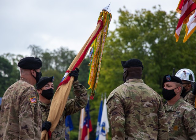 Maj. Gen. John P. Sullivan, commanding general, 1st Theater Sustainment Command, passes the unit colors to Command Sgt. Maj. Michael J. Perry III, incoming command sergeant major, 1st TSC, charging him with the responsibility as the unit’s new senior enlisted advisor during a ceremony held at Fort Knox, Kentucky, July 28 2020. (U.S. Army photo by Spc. Zoran Raduka, 1st TSC, Public Affairs)