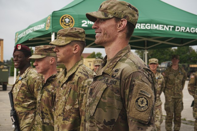 U.S. Soldiers, assigned to the 2d Cavalry Regiment and the 7th Army Training Command, smile after receiving badges and Army Achievement Medals for best times for the Expert Infantry Badge and Expert Soldier Badge events in Vilseck, Germany, June 5, 2020. The purpose of the EIB and ESB is to recognize Soldiers who have demonstrated a mastery of critical tasks to build upon the foundation of individual proficiency. (U.S. Army photo by Sgt. LaShic Patterson)