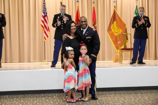 Warrant Officer 1 Brandon McMillian poses for a photo with his wife and two kids after they pinned the new rank onto McMillian’s uniform at the first warrant officer appointment ceremony held at the Kansas Regional Training Institute in Salina,...