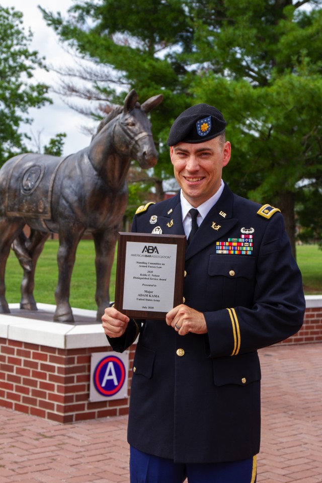 Maj. Adam Kama, deputy judge advocate, 1st Theater Sustainment Command, stands in front of Fowler Hall as the recipient of the Keithe E. Nelson Distinguished Service Award at Ft. Knox, Kentucky, July 28, 2020. According to the American Bar...