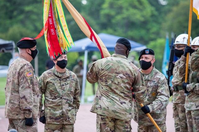 Command Sgt. Maj. Carey Welsh, senior enlisted advisor, Special Troops Battalion, 1st Theater Sustainment Command, passes the unit colors to Command Sgt. Maj Bernard P. Smalls Sr., outgoing senior enlisted advisor, 1st TSC, during a change of responsibility ceremony held at Fort Knox, Kentucky, July 28, 2020. (U. S. Army Photo by Spc. Kaylee Harris, 1st TSC Public Affairs)