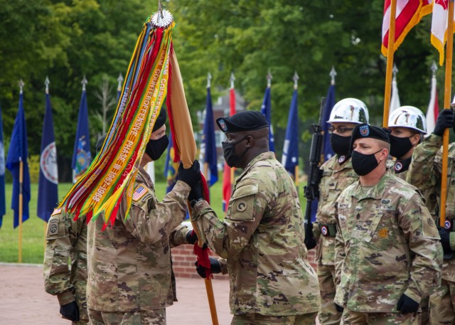 Command Sgt. Maj. Bernard P. Smalls Sr., outgoing senior enlisted advisor, 1st Theater Sustainment Command, conducts a change of responsibility as he passes the unit colors to Maj. Gen. John P. Sullivan, commanding general, 1st TSC, during a ceremony held at Fort Knox, Kentucky, July 28 2020. (U.S. Army photo by Spc. Zoran Raduka, 1st TSC, Public Affairs)